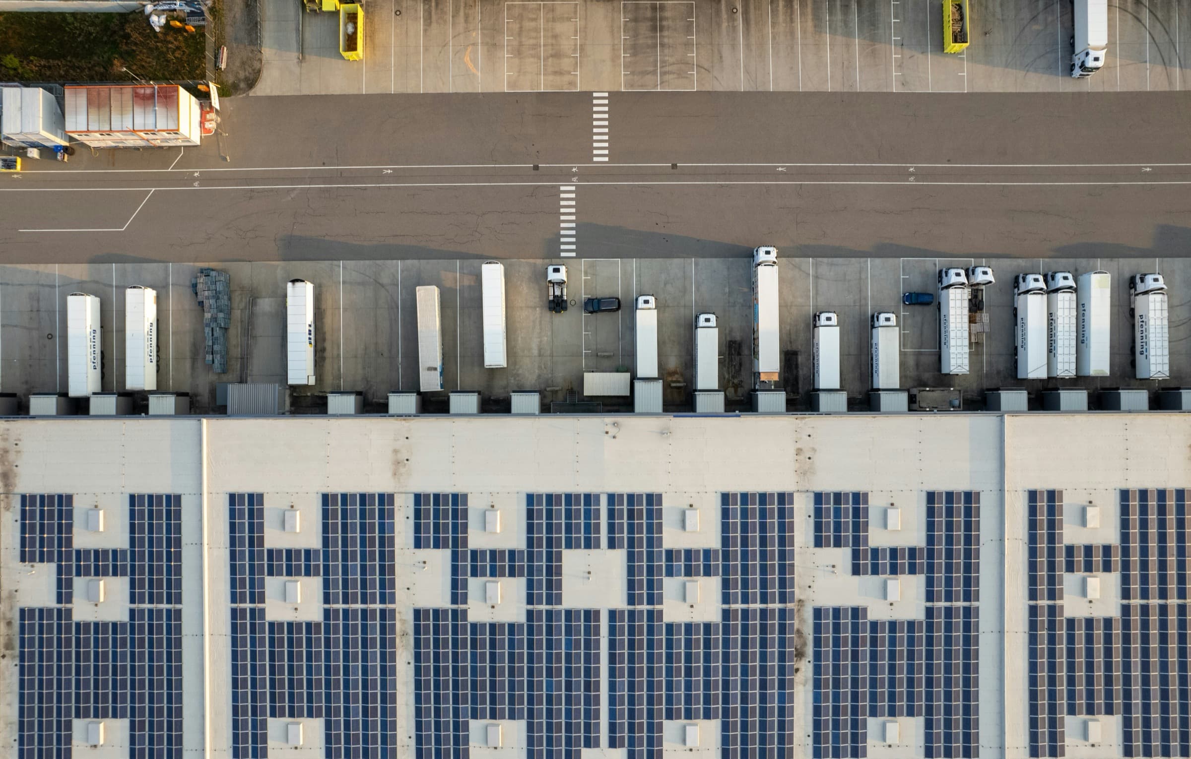Overhead view of a commercial warehouse, loading docks, and truck access lanes